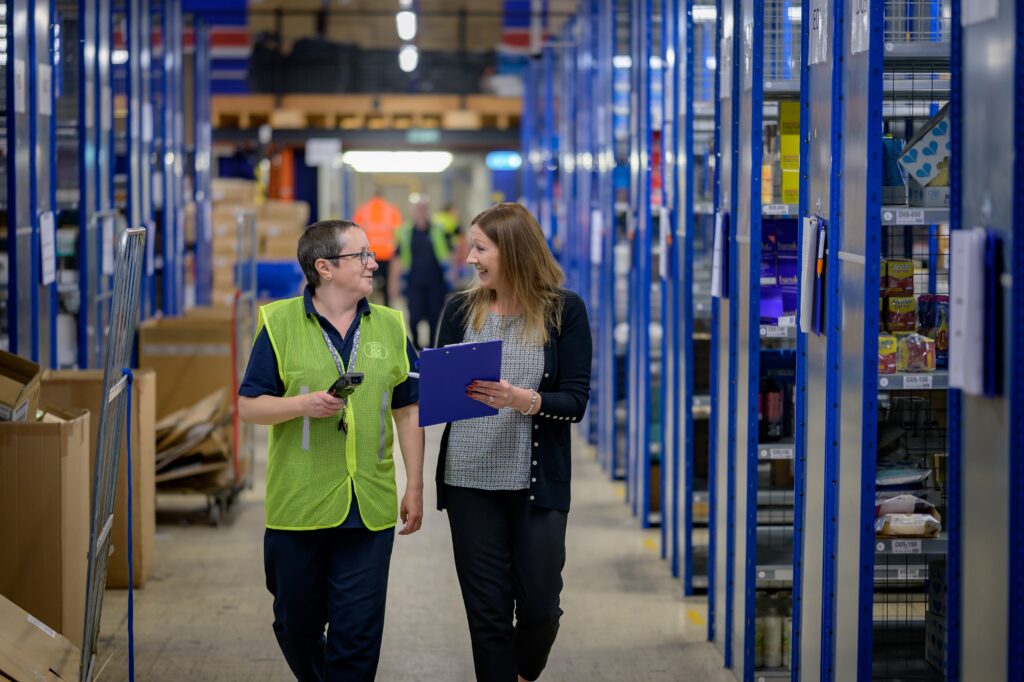 Stock image of people in a warehouse to accompany article on warehouse setup mistakes to avoid 