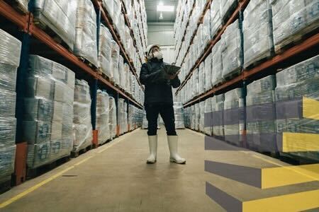 A man in a logistics facility to illustrate article on setting up a warehouse distribution center
