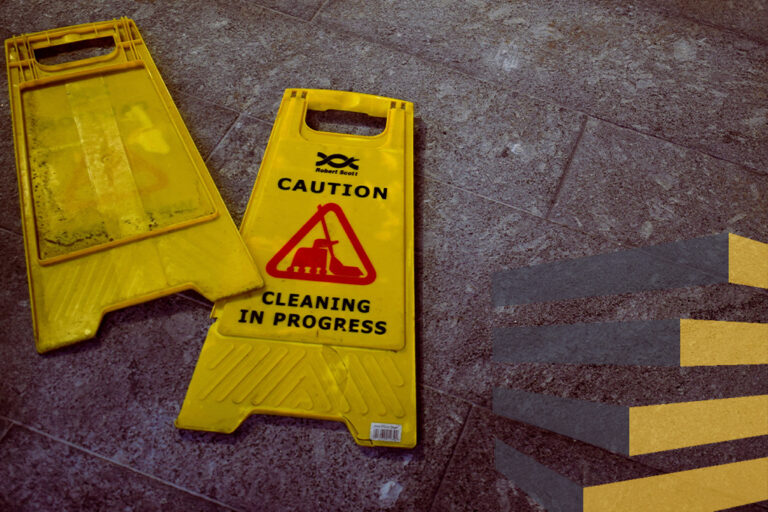 Cleaning signs on floor to illustrate article on the cleaning of industrial warehouses in Mexico. By Oliver Hale on Unsplash