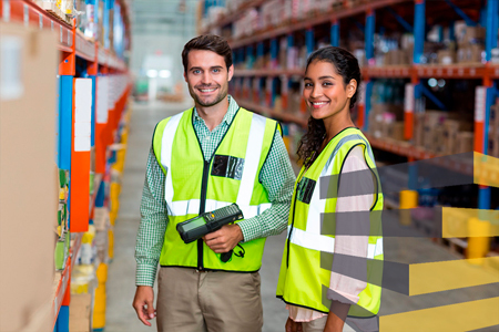 Two people in a logistics facility to illustrate article on warehouse barcode system implementation