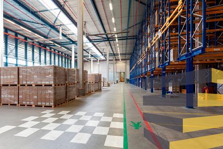 A number of different warehouse floor demarcation markings in a single zone.