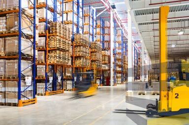 Forklifts working in storage centre to illustrate article on warehouse racking in Brazil.