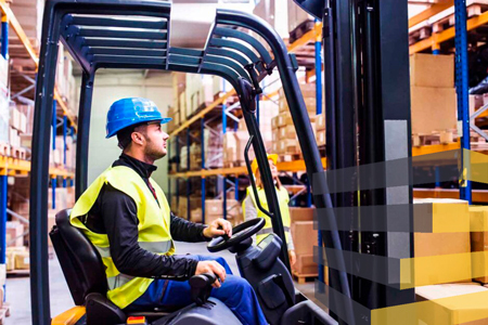 A stock photo of a forklift driver to accompany article on outsourcing recruitment of warehouse workers.
